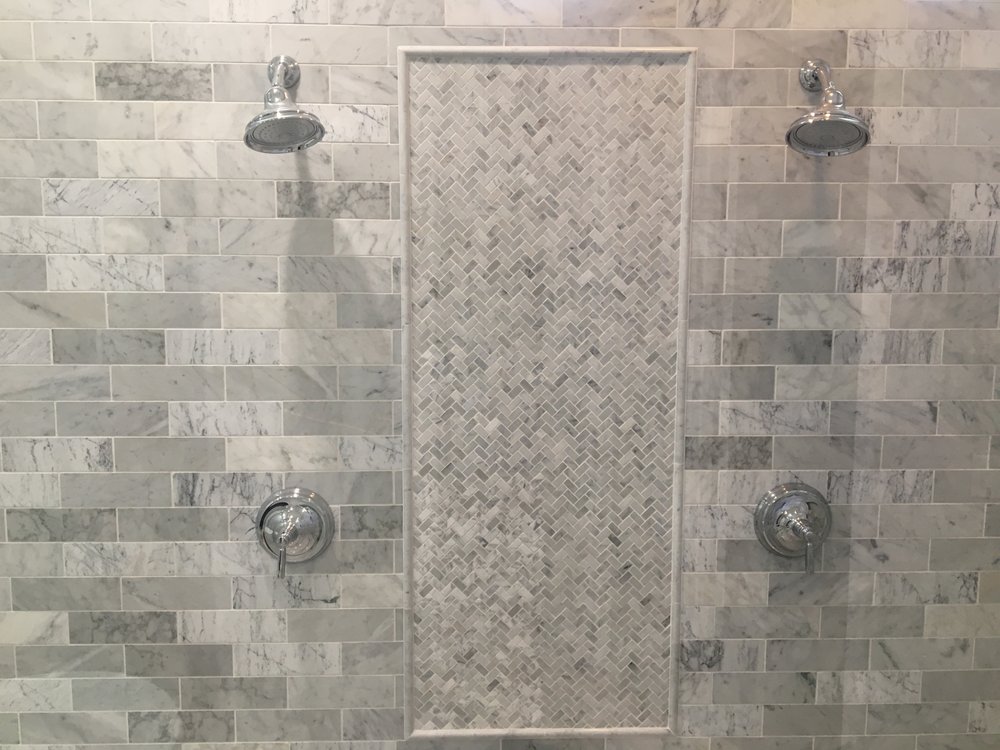Marble subway shower with herringbone inlay and dual shower — Bathroom Remodeling by Urban Element, Inc. in the East Valley of Arizona